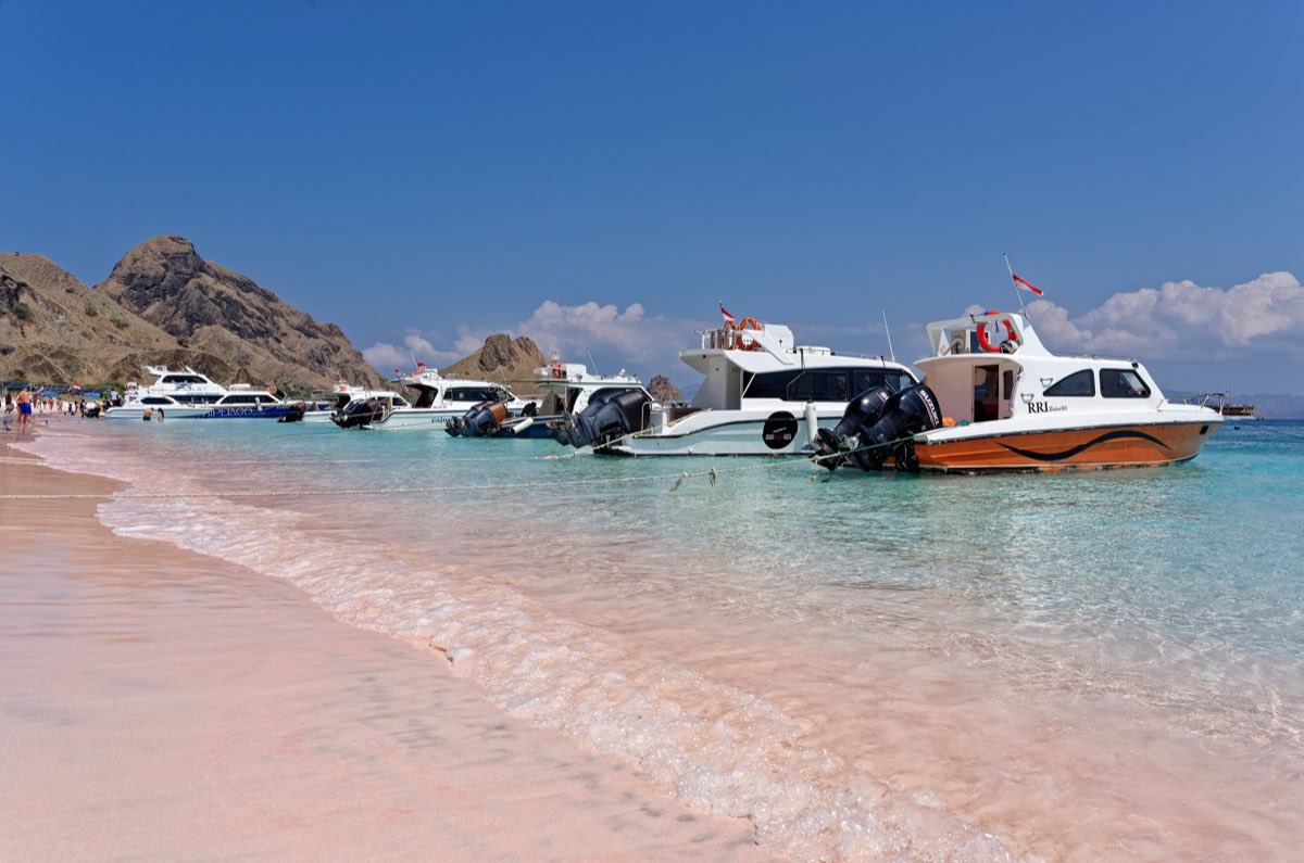 Pink-tinged sand meeting clear turquoise shallows at Pink Beach, Komodo.