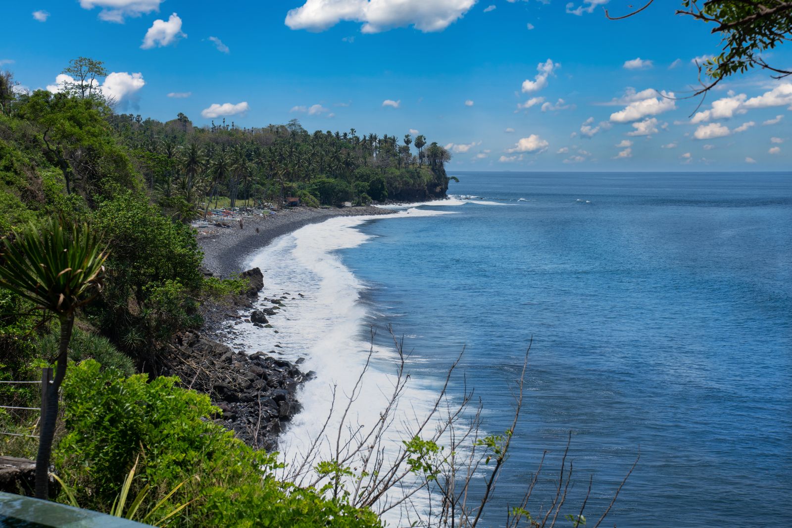 The rocky coastline and clear water of east Bali.
